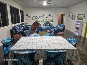 a living room with a table and couches at Heleni Jessop's Fatahega in Alofi