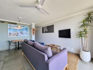 a living room with a couch and a table at 77 Chaka's Cove in Ballito