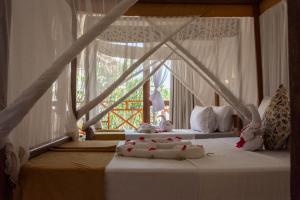 a bedroom with two beds and a window at Nungwi Garden Boutique Hotel in Nungwi