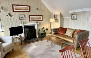 a living room with a couch and a fireplace at Florrie's in Stein