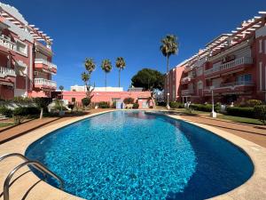 a swimming pool in front of some apartment buildings at Jazmines 5 in Denia