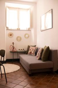 salon z kanapą i oknem w obiekcie Civico 18 w Katanii