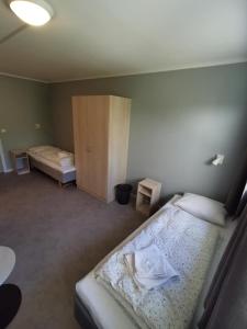 een kleine slaapkamer met 2 bedden en een kast bij BiG Event AS in Grimstad