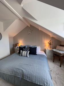 a bedroom with a large bed in a attic at Efail Fach in New Quay