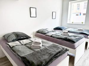 two beds in a bedroom with towels on them at Beautiful Apartment in Düren in Düren - Eifel