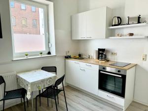 a kitchen with a table and chairs and a window at Beautiful Apartment in Düren in Düren - Eifel