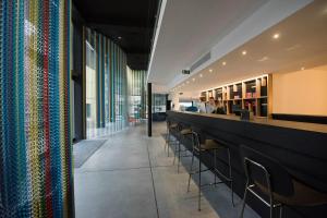 a bar with a row of chairs in a restaurant at room00 Lisboa Hostel in Lisbon