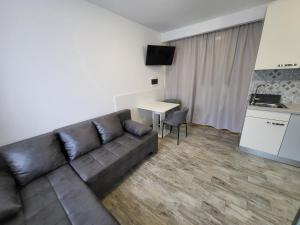 a living room with a couch and a table at Studio Morsal in Koper +2 photos