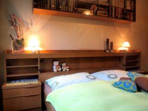 a bedroom with a bed with two stuffed animals on it at Ferienwohnung Angelika in Bad Schallerbach +19 photos