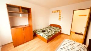 - une petite chambre avec un lit et une étagère dans l'établissement C-House Inchiriaza Apartament 2 Camere in Regim Hotelier, à Râmnicu Vâlcea