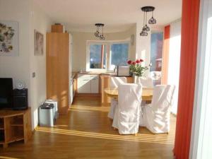 a dining room with a table and white chairs at Ferienwohnung Wilhelm in Sautens +37 photos