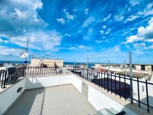 a balcony with a view of the ocean at Casa Carlotta Apartments in Terrasini