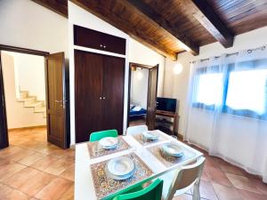 a dining room with a table and chairs at Casa Carlotta Apartments in Terrasini