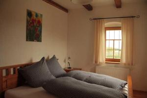 a bedroom with a bed and a window at Kellerstöckl 