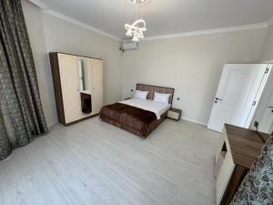 a hotel room with a bed and a mirror at VIP Family Villa HOT POOL in Gabala