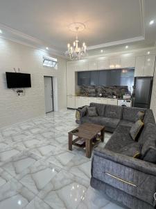 a living room with a couch and a table at VIP Family Villa HOT POOL in Gabala +17 photos