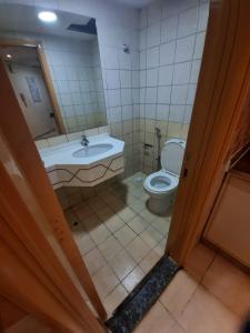 a bathroom with a toilet and a sink at DUBAI METRO Al karama building in Dubai