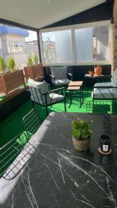 een patio met stoelen en een tafel met een potplant bij Sisli Osmanbey Taksim large terrace, quietness and space in Istanbul
