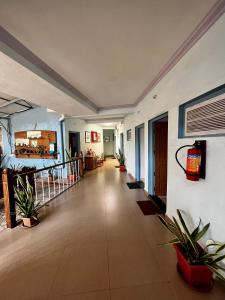 an empty hallway with plants in a building at Easy Living Guesthouse in Varca