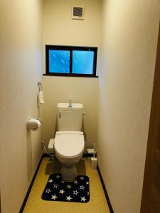 a small bathroom with a toilet in a room at Urasa Cottage @ Snow Countryside in Minami Uonuma