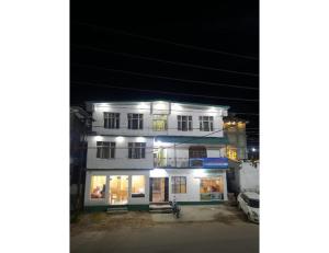 a white building with lights on it at night at HOTEL HIMGIRI, Shri Badrinath in Badrinath