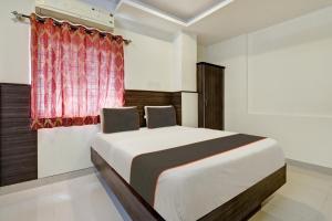 a bedroom with a large bed with a window at HOTEL VISA INN NEAR KEMPEGOWDA AIRPORT in Bangalore