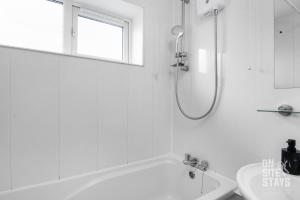 a white bathroom with a tub and a sink at OnSiteStays 4-BR, Wifi and lots of parking in Hatfield
