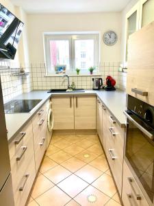 a kitchen with white counters and a sink and a window at Zimtstern-West in Stuttgart