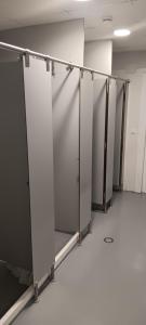 a row of stalls in an empty room at Albergue Santiago Apostol in Logroño
