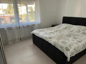 a bed in a room with a window and a bedskirtspectspectspectspects at Ferienwohnung in Sinzheim bei Baden Baden für 1- 6 Personen in Sinzheim