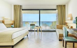 a hotel room with a bed and a desk and a bedroom at Capovaticano Resort Thalasso Spa in Capo Vaticano
