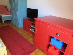 Ferienwohnung am Gässle في إيتينهايم: خزانة ملابس حمراء مع تلفزيون فوقها