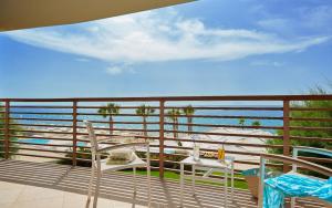 a balcony with chairs and a view of the ocean at Capovaticano Resort Thalasso Spa in Capo Vaticano