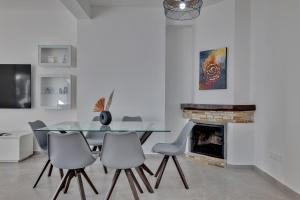 a dining room with a glass table and chairs at Phaedrus Living: Luxury Residence Faneromeni in Larnaca