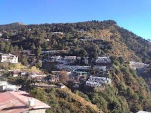 a town on top of a hill with houses at Goroomgo Shah Guest House Nainital - Excellent Customer Service in Nainital