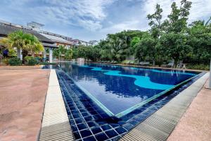a swimming pool in a resort with blue water at Eastiny Resort & Spa in Nong Prue