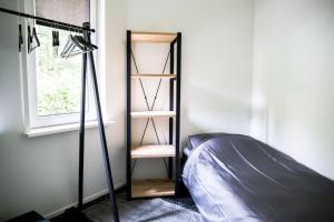 a room with a book shelf next to a bed at COSY Holiday Home in Harderwijk +14 photos