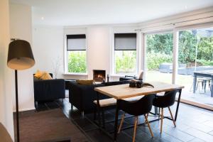 a living room with a table and a couch at COSY Holiday Home in Harderwijk