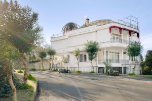 a white building on the side of a street at Sea View Retreat in Buyukada 1 min to Ferry in Istanbul