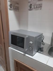 a microwave sitting on top of a counter at Cotonou appart in Cotonou