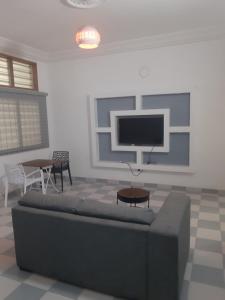 a living room with a couch and a flat screen tv at Cotonou appart in Cotonou