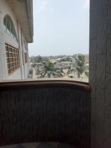 a view from a window of a building with palm trees at Cotonou appart in Cotonou