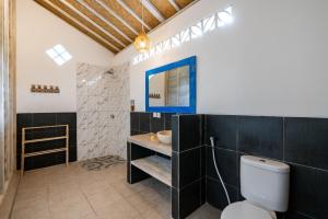 a bathroom with a toilet and a sink at Le Biu garden View in Nusa Lembongan