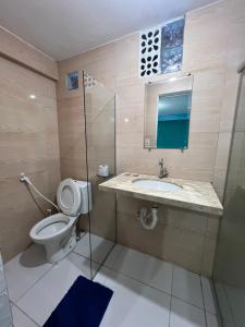 a bathroom with a toilet and a sink and a shower at Ladeira de Olinda in Olinda