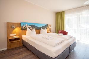 Postel nebo postele na pokoji v ubytování Burghotel Aschau