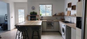 a kitchen with a counter with stools in it at Family Home - Between Monaco, Menton & Gorbio - Beautiful in Gorbio