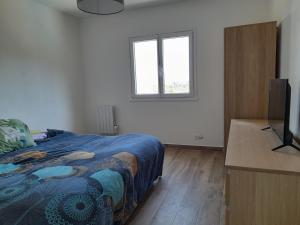 a bedroom with a bed and a flat screen tv at Family Home - Between Monaco, Menton & Gorbio - Beautiful in Gorbio +29 photos