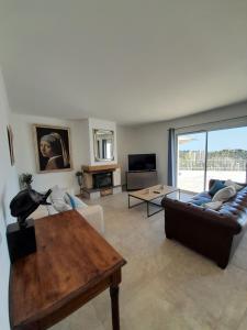 a living room with a couch and a table at Family Home - Between Monaco, Menton & Gorbio - Beautiful in Gorbio