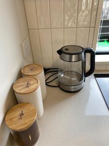 a kitchen counter with a coffee pot on a counter top at Charming Retreat in the Heart of Christchurch City-CBD 