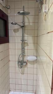 a shower with a toilet in a tiled bathroom at ظلال النزلاء in Jarwal